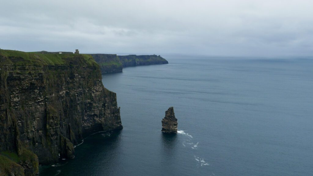 The Cliffs of Moher meet the blue-grey water and the ominous clouds. 

Location: Cliffs of Moher, County Clare, Ireland 
Photo Credit: Anika Kan Grevstad 