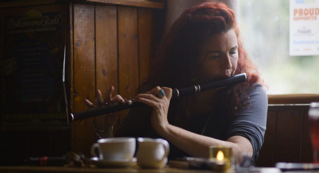 A woman with bright red hair plays the flute next to a bright window.
Location: The Roadside Tavern in Lisdoonvarna, County Clare, Ireland
Subject: Katie Theasby
Photo Credit: Anika Kan Grevstad
